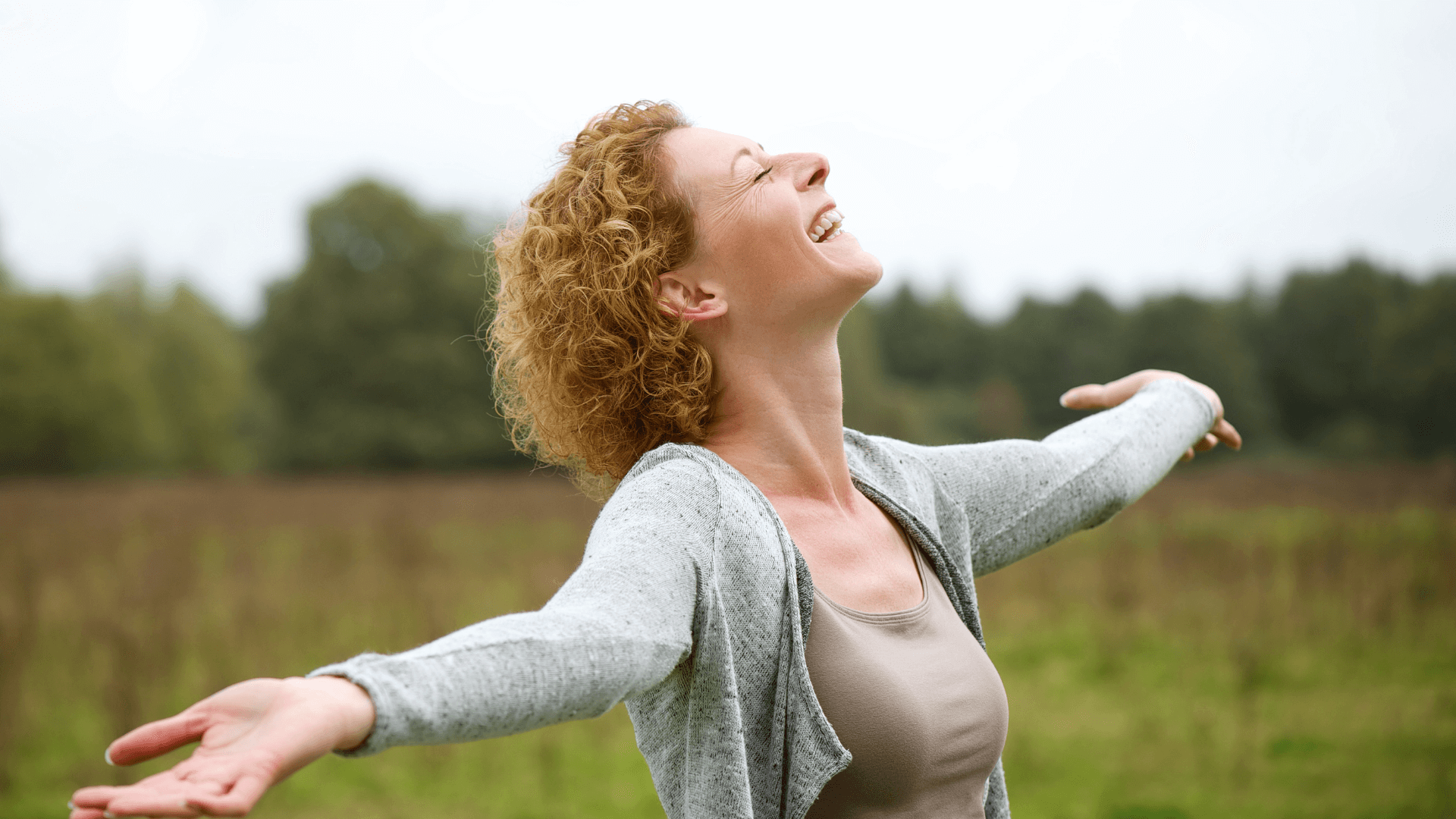 A woman standing on top of a lush green field