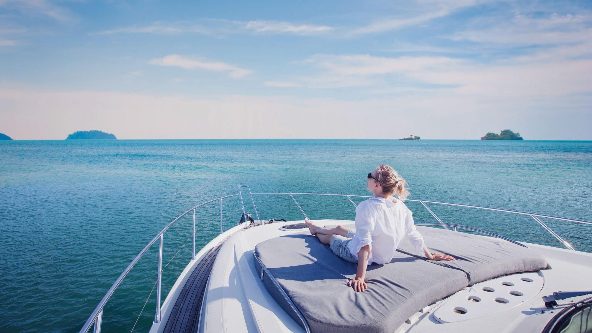 a woman is sitting on the back of a boat