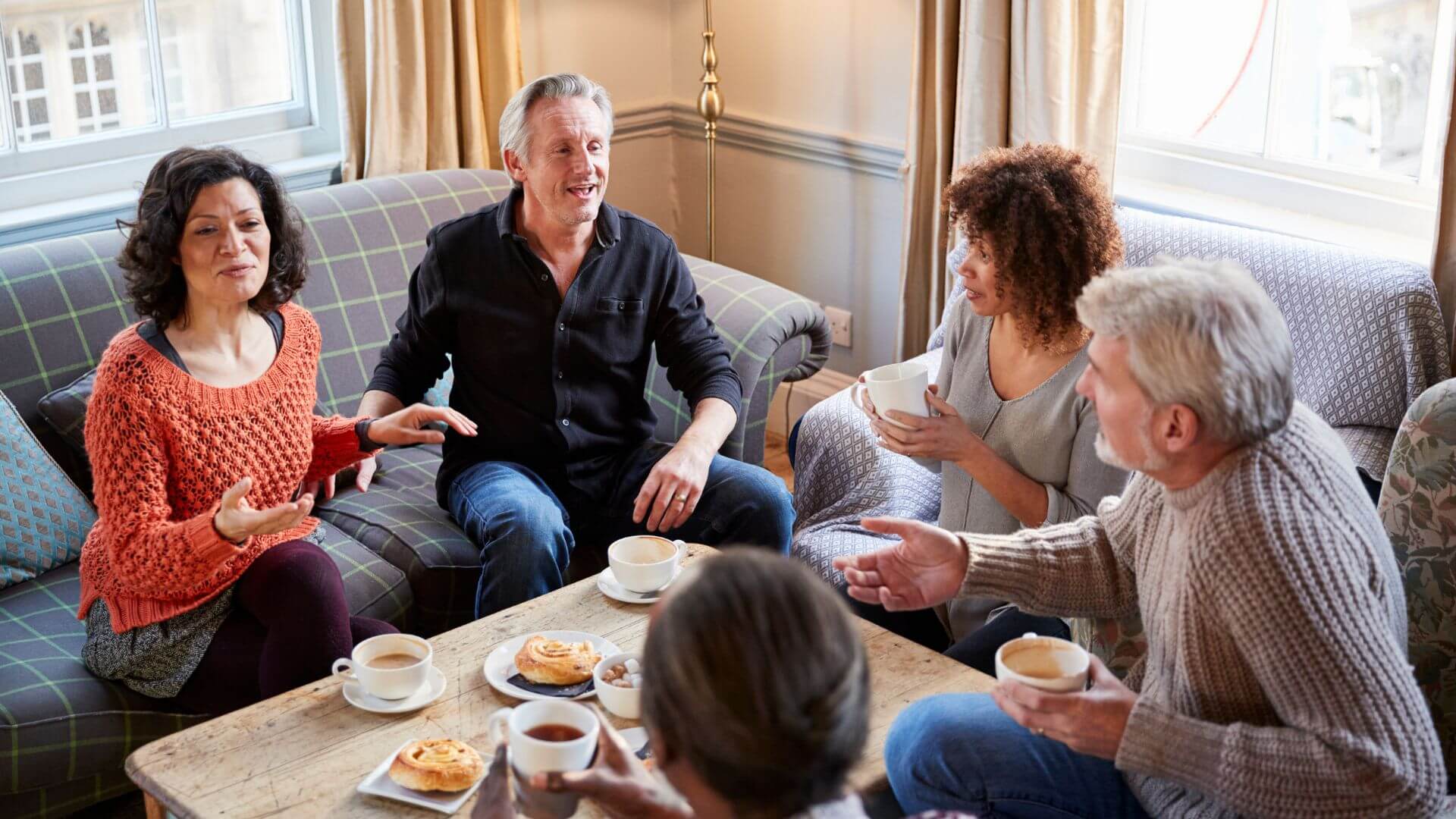 a group of people sitting around a coffee table
