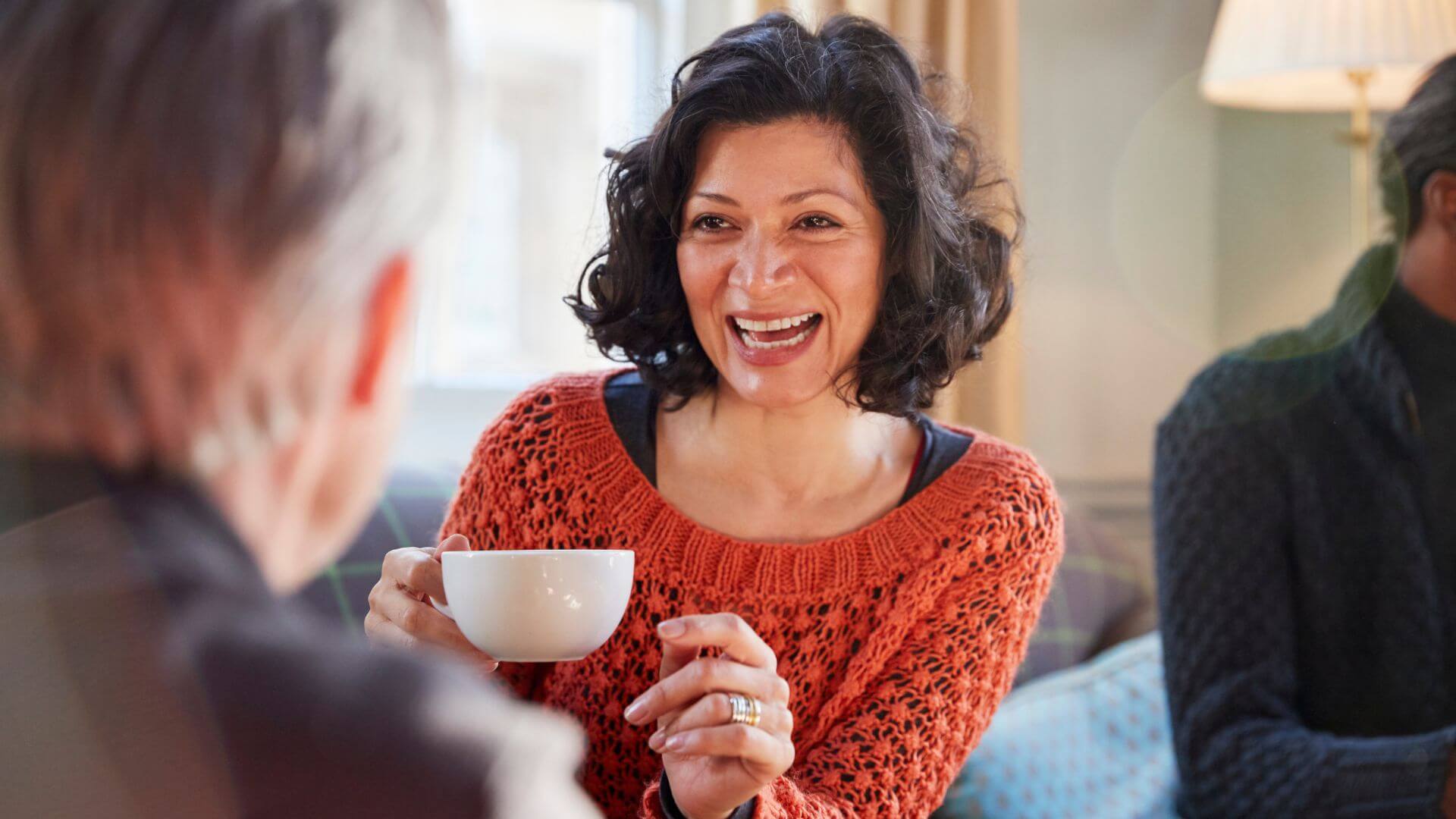a woman and a man are having a conversation in a coffee shop