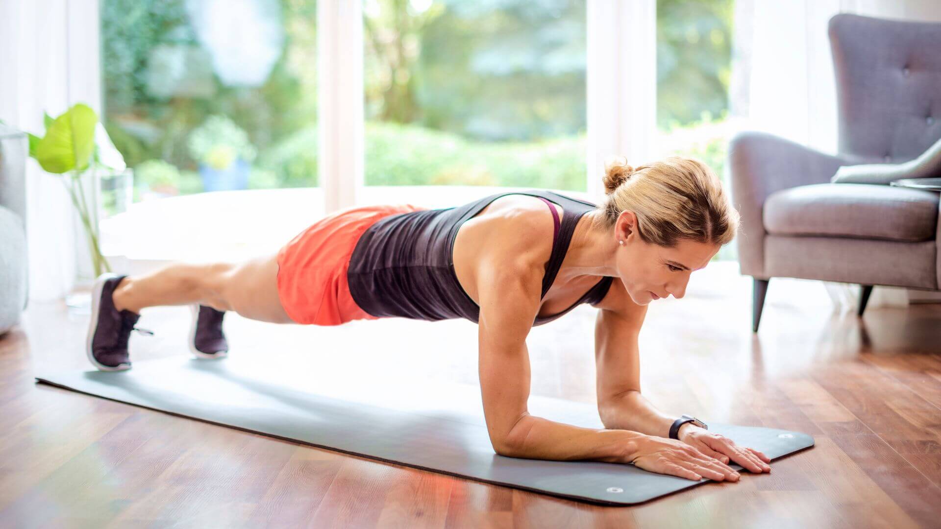 a woman doing plank exercises in her living room